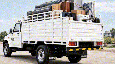 Movers loading Bolero truck with furniture in Vijay Nagar